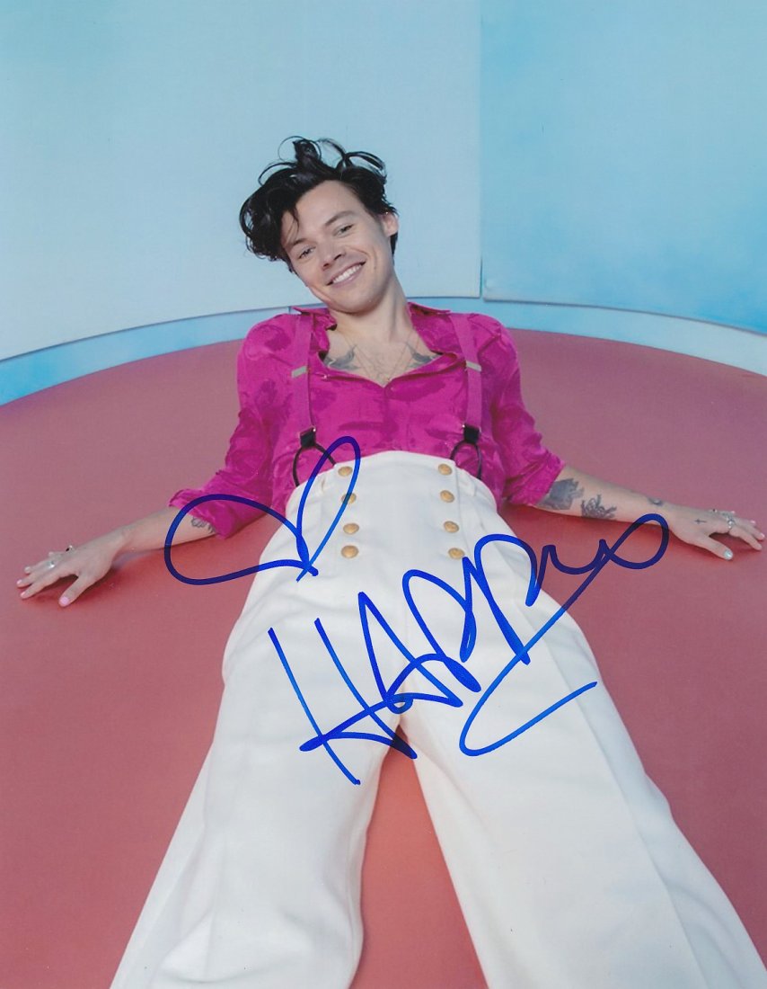 Harry Styles-Signed Photograph: 8x10 Color satin finish photograph signed in blue felt tip ink by Harry Styles. In mint condition. Comes with a full Letter of Authenticity from Todd Mueller Authentics.