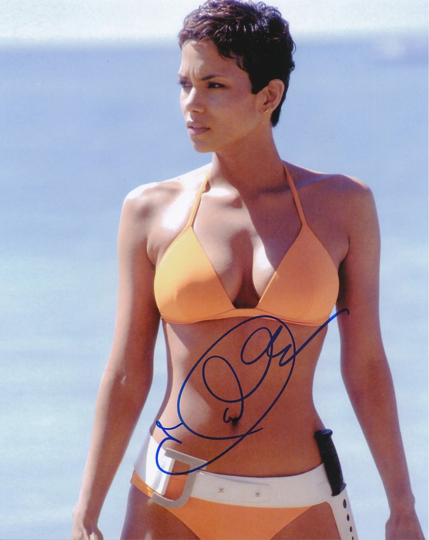 Halle Berry-SEXY Signed Photograph from "James Bond": 10x8 Color satin finish photograph from "James Bond" and signed in blue felt tip ink by Halle Berry. Excellent condition.If the lot sells for $10 or more it will come with a full Letter of Authenticit