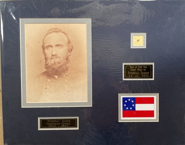 Stonewall Jackson- Piece of his Worn Civil War Scarf Matted: Limited Edition 34 of 300. Small piece of Stonewall Jackson's worn Civil War scarf matted with a photograph, two name plates to an overall size of 20X16. Comes with a COA from John Reznikoff.