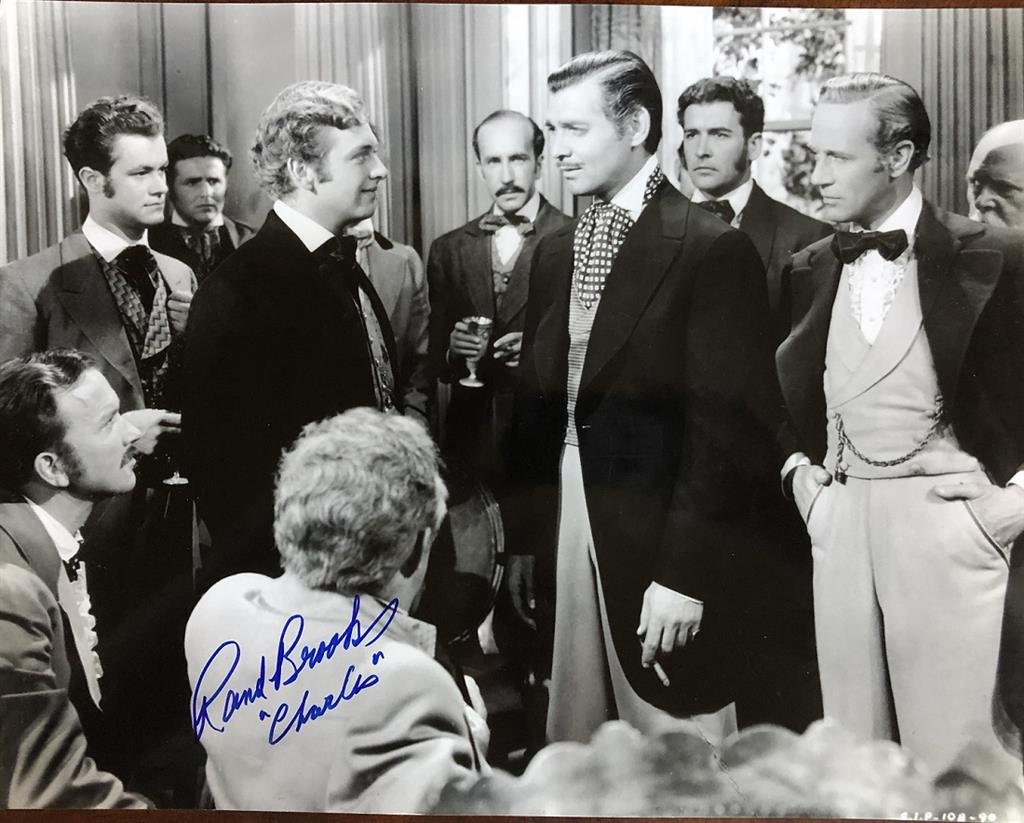 Rand Brooks- 14X11 GWTW Signed Photograph with Clark Gable: 14X11 B&W Glossy photograph from, "Gone with the Wind," depicting Rand Brooks with Clark Gable. Signed during our private signing with Rand Brooks adding "Charles" under his signature. In very good co