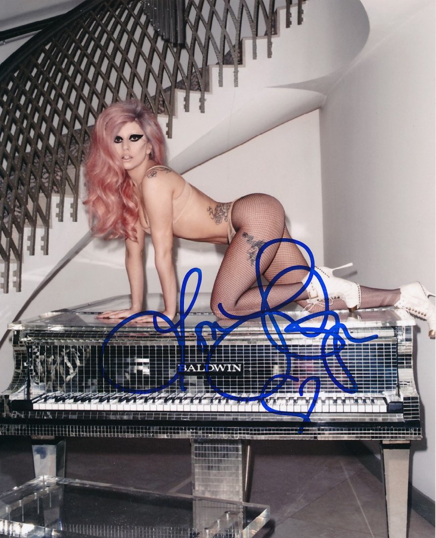 Lady Gaga-SEXY Signed Photograph: MINT CONDITION SEXY 8x10 Color satin finish photograph signed in blue felt tip ink by Lady Gaga. Comes with a full Letter of Authenticity from Todd Mueller Authentics.
