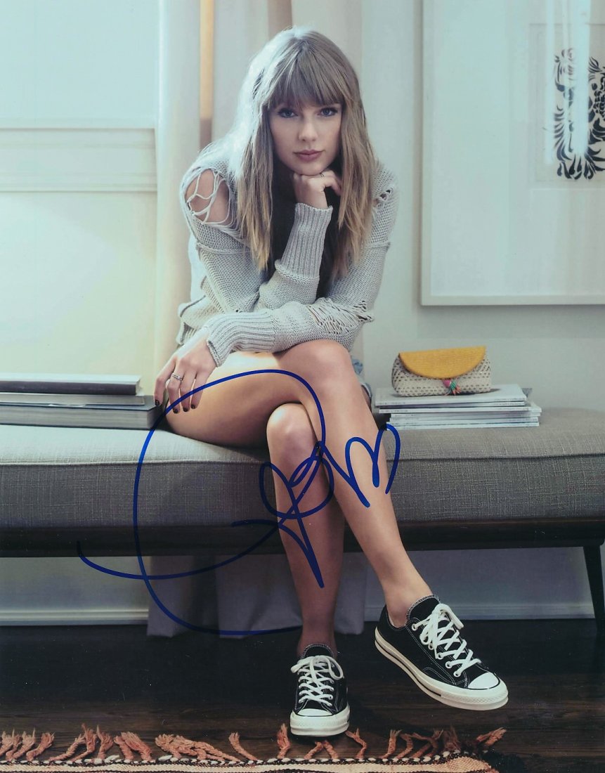 Taylor Swift-Signed Photograph: 8x10 Color satin finish photograph signed in blue felt tip ink by Taylor Swift. In excellent condition.Comes with a full Letter of Authenticity from Todd Mueller Authentics.