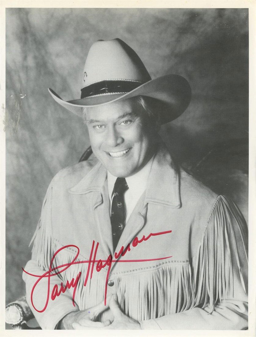 Larry Hagman- Signed Photograph: 8.5x11 B&W thin cardstock photograph signed in red felt tip ink by Larry Hagman. Some edge creasing, otherwise, in good condition. (1931-2012) Larry Hagman was an American film and television actor, d