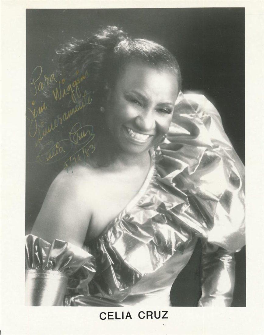 Celia Cruz- Vintage Signed Photograph (Famous Latin Artist): 8X10 B&W Glossy vintage photograph signed in gold ink, "Para Jim Wiggins, Sinceramento Celia Cruz 9/26/83." In very good condition.(1925-2003) Celia Cruz was a naturalized Cuban-American singer and on