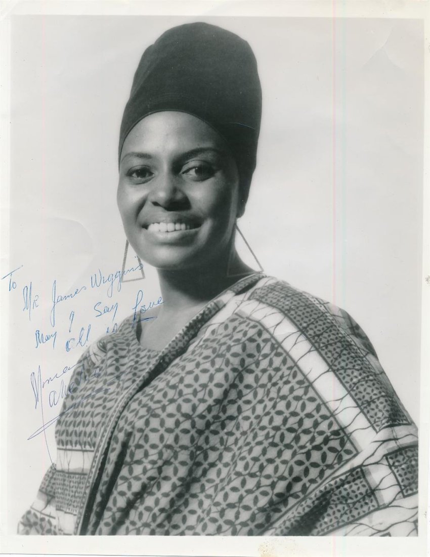 Miriam Makeba- Signed Vintage Photograph ("Mama Africa"): 8X10 Vintage B&W glossy photograph signed, "To Sir James Wiggins May I say all is Love Monica Arnold" in blue ballpoint ink. Scattered creasing, otherwise in fair condition. (1932-2008) Zenzile Miriam