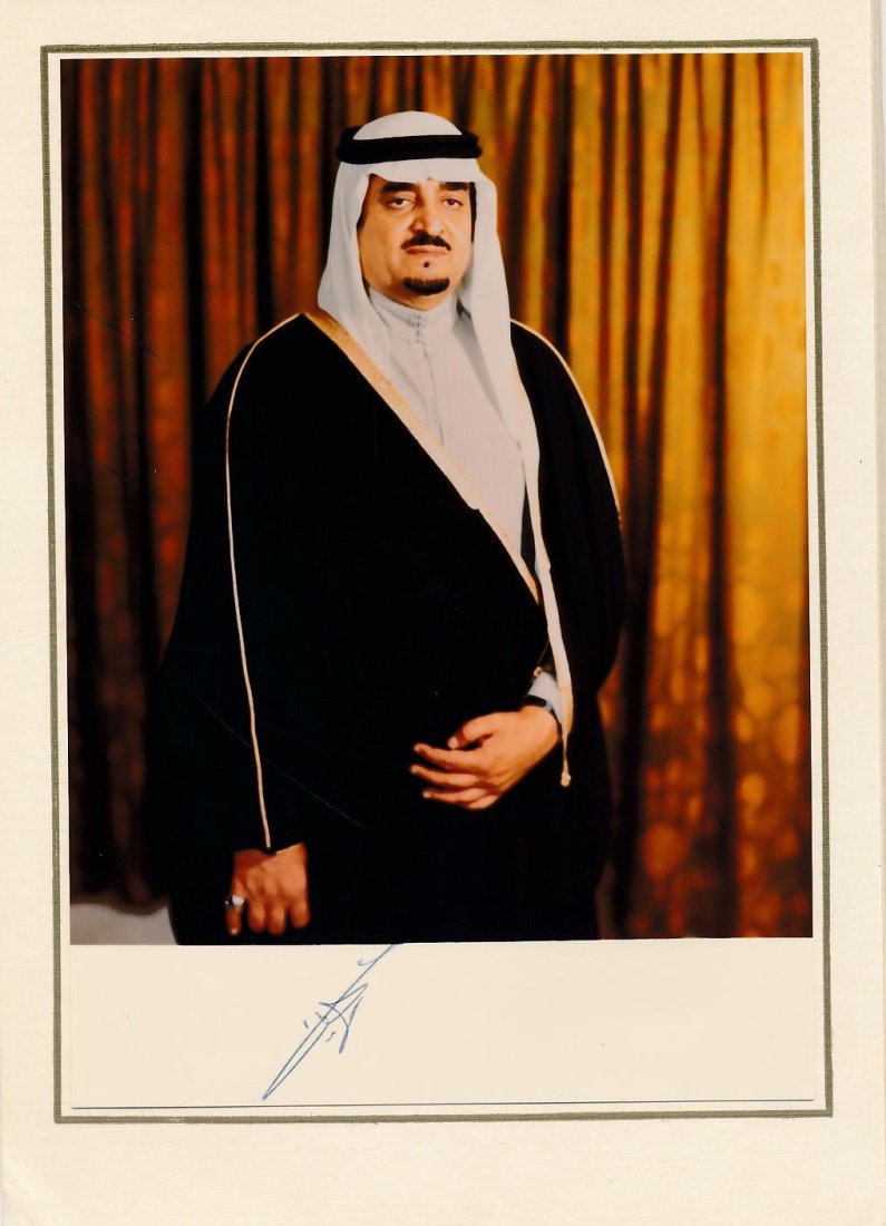 Fahd of Saudi Arabia-Vintage Signed Official Portrait Photograph: Official 6x8 portrait photograph affixed into fold open card of Fahd of Saudi Arabia. Signed on the lower margin in blue by Fahd of Saudi Arabia. Excellent condition. (1920/21/23-2005) Fahd bin Abdula