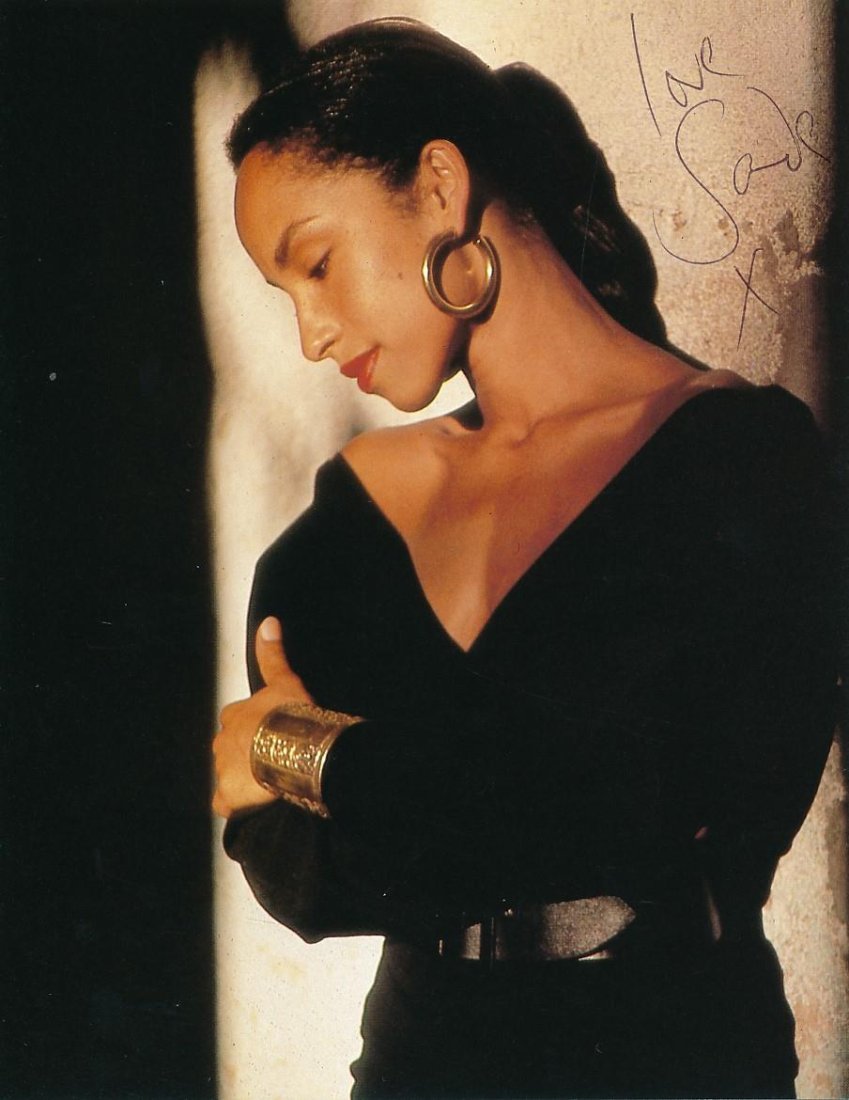 Sade- Signed Color Photograph: 6x8 Color photograph signed "Love Sade X" in black ballpoint ink. Excellent condition. Sade is a Nigerian-born British singer, known as the lead vocalist of her band Sade. One of the most successful B