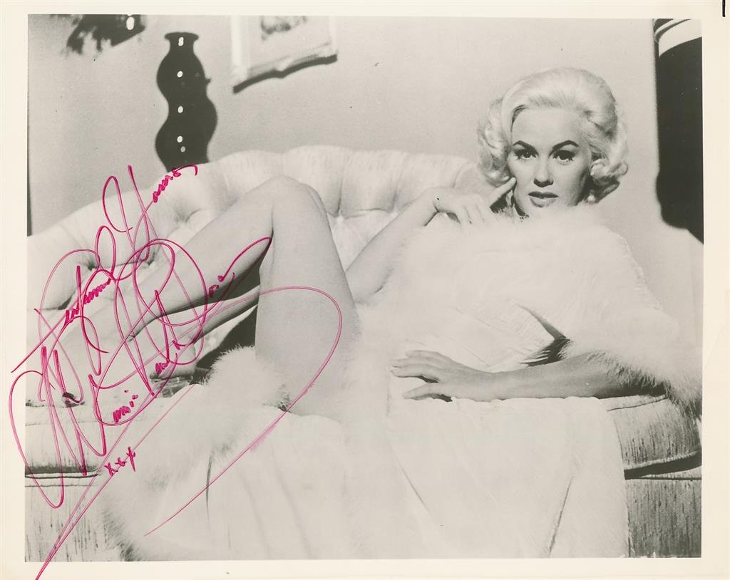 Mamie Van Doren- Signed Vintage Photograph: 10x8 B&W glossy vintage photograph signed in red felt tip ink by Mamie Van Doren. A very light crease on the lower right corner, otherwise, excellent. Mamie Van Doren is an American actress, singer, a
