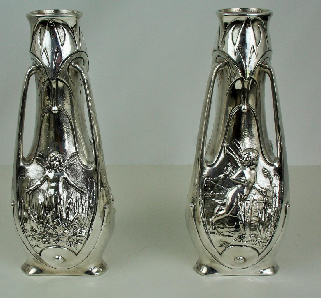 Antique Art Nouveau Pixie Vases (Pair): A pair of Art Nouveau Pixie Vases. White metal with a silver plated finish. Missing the glass liners. Signed J. Garnier. Circa 1890's. 15"H and 6" across.