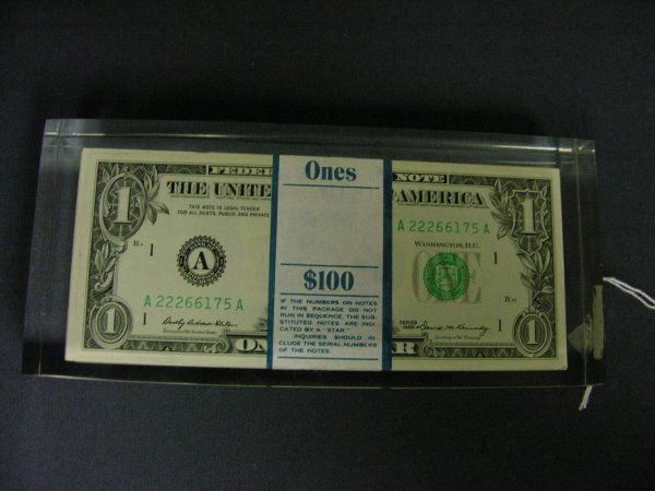 100 1969 U.S. ONE DOLLAR BILLS ENCASED: 100 1969 U.S. ONE DOLLAR BILLS ENCASED Encased in plastic as a paper weight.