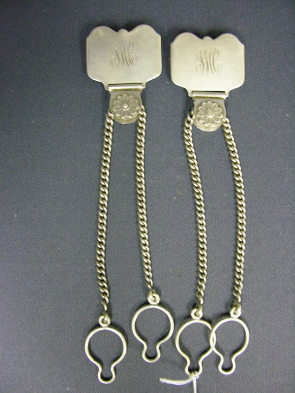 PAIR MATCHING STERLING CHATELAINES GORHAM: PAIR MATCHING STERLING CHATELAINES GORHAM Monogrammed, Gorham mark sterling 38 with 8 laying on side. Floral medallion with chain having two key rings. Weight: 1.92904 troy oz.