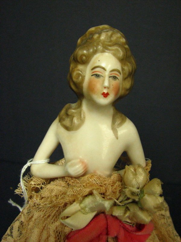 VINTAGE BOUDOIR LAMP DOLL PORCELAIN HALF DOLL: VINTAGE BOUDOIR LAMP DOLL PORCELAIN HALF DOLL China half doll over wire frame, fitted with light socket, old electrical wiring. Circa 1924. Size: 11 1/4'' tall 5 1/4'' diameter.