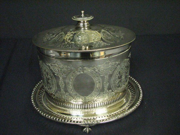 TEA CADDY SILVER PLATE: TEA CADDY SILVER PLATE Attached tray with claw feet. Has HAEAFAEPA cross on the bottom (see photos) Size: 8'' x 9 1/4''