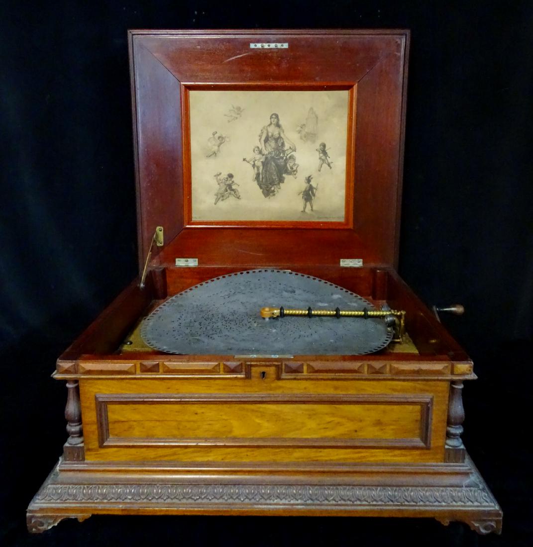 REGINA CARVED WALNUT MUSIC BOX: REGINA CARVED MAHOGANY MUSIC BOX ACANTHUS DETAIL; ORIGINAL REGINA LITHOGRAPH 12"H 21"W 19"D WITH 6 DISCS ( 15.5 DISC SIZE)SOUSA - WASHINGTON POST MARCHVERNER - PRIDE OF THE BALL WALTZ SONG OLD HUNDRED