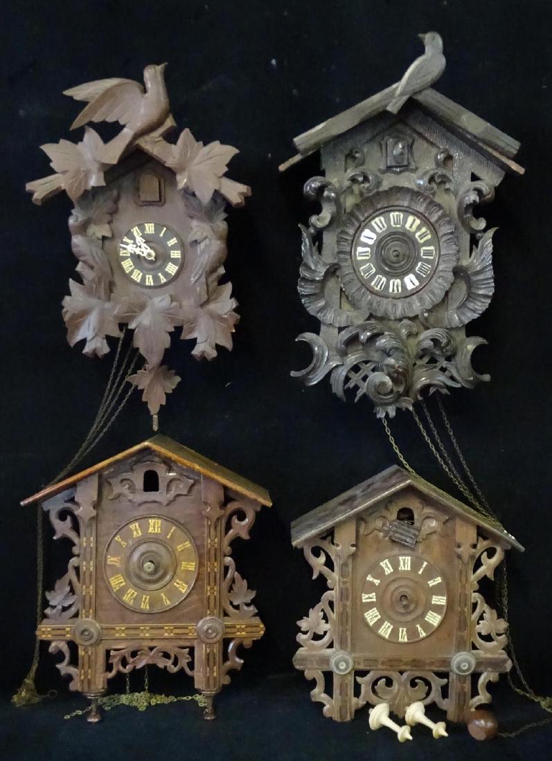 4 CUCKOO CLOCKS ( 1 BLACK BIRD & LEAF, 1 CARVED SCROLL,: 4 CUCKOO CLOCKS ( 1 BLACK BIRD & LEAF, 1 CARVED SCROLL, 2 INLAID GOTHIC) 19" TALLEST