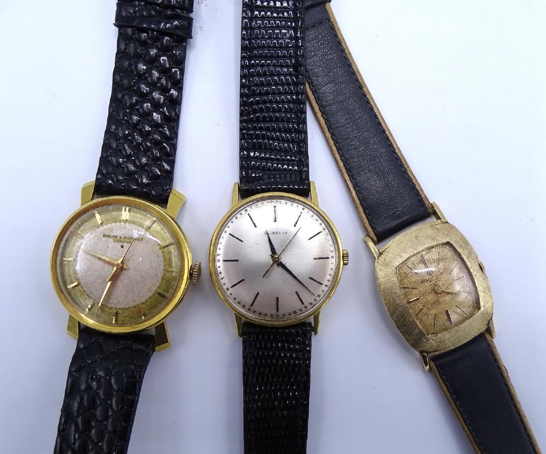 THREE 14KT MENS WRIST WATCHES: GUBELIN, 2 BAUME &: THREE 14KT MENS WRIST WATCHES: GUBELIN, 2 BAUME & MERCIER