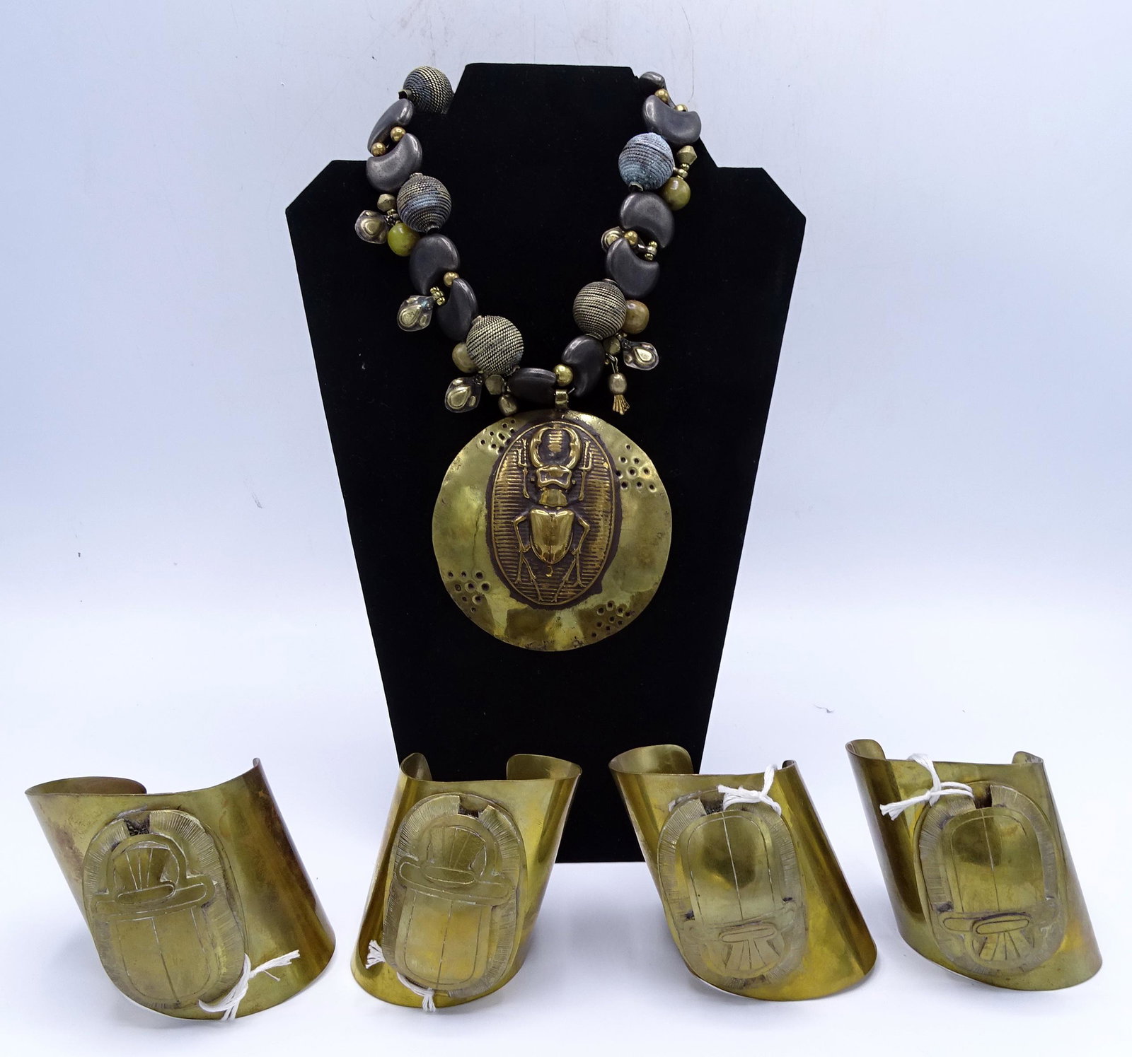 C. 1970 BRASS SCARAB NECKLACE & 2 PR. SCARAB CUFF: C. 1970 BRASS SCARAB NECKLACE & 2 PR. SCARAB CUFF BRACELETS (GEOFFREY BEENE FOUNDATION)