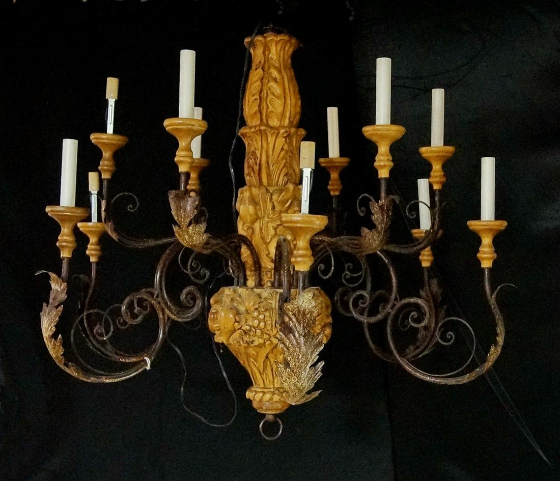 WROUGHT IRON AND CARVED WOOD CHANDELIER: WROUGHT IRON AND CARVED WOOD CHANDELIER