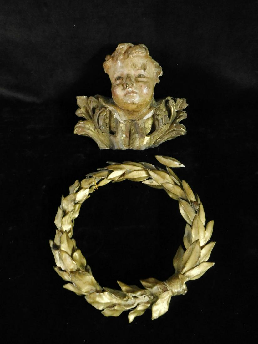 ITALIAN PUTTO WITH FOLIATE DETAILS AND CARVED WOOD LAUREL WREATH 9.5HX10WX5D. WREATH DIA. 11.5 REF#: ITALIAN PUTTO WITH FOLIATE DETAILS AND CARVED WOOD LAUREL WREATH 9.5HX10WX5D. WREATH DIA. 11.5 REF# (582)