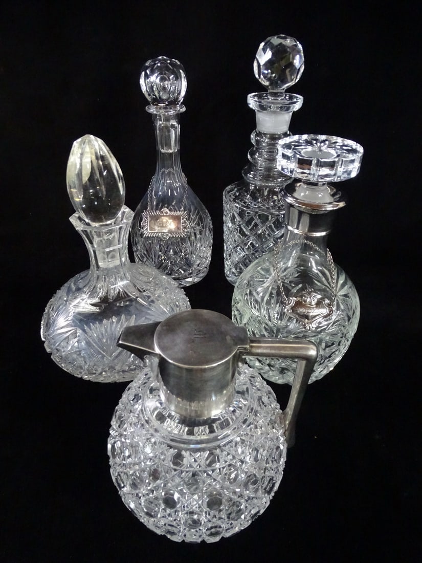 GROUP OF 5 CRYSTAL DECANTERS 1 W/STERLING HANDLE AND SPOUT 12 1/2" TALLEST: GROUP OF 5 CRYSTAL DECANTERS 1 W/STERLING HANDLE AND SPOUT 12 1/2" TALLEST