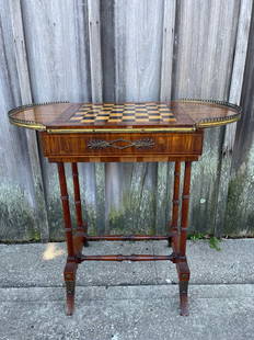 VINTAGE ROSEWOOD GAME TABLE W/BRASS GALLERY DETAIL & CHESS BOARD TOP WHICH SLIDES TO REVEAL: VINTAGE ROSEWOOD GAME TABLE W/BRASS GALLERY DETAIL & CHESS BOARD TOP WHICH SLIDES TO REVEAL BACKGAMMON BOARD - 28" H X 30" W X 16" D, SOME LOSSES, VENEER PIECES IN DRAWER