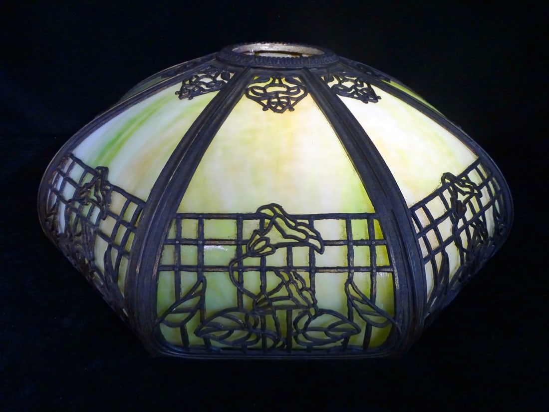GREEN SLAG GLASS 8 PANEL SHADE W/FILIGREE METAL OVERLAY 7" X 17" X 18": Imbue your home with a touch of vintage charm with this stunning 8-panel slag glass lamp shade. Crafted from green slag glass with a beautiful filigree metal overlay, this lamp shade exudes the elegan