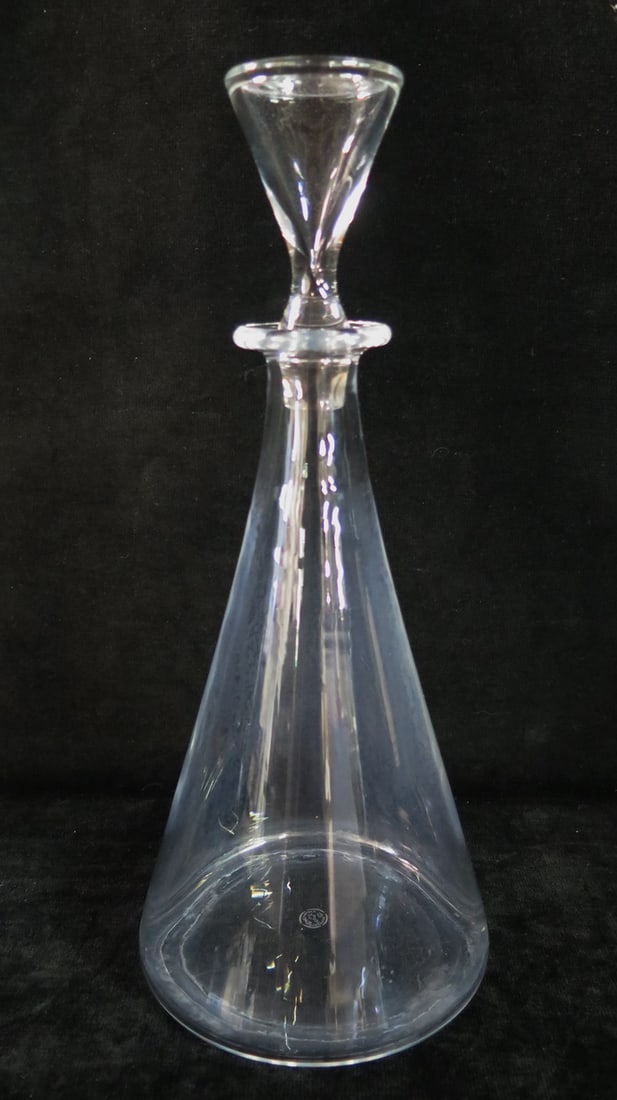 ESTATE OF DENNIS P. RODANO: BACCARAT CRYSTAL DECANTER 12" HIGH: Elevate your home bar with this sophisticated Baccarat crystal decanter. The image you sent depicts a clear, conical decanter sitting atop a black table. This 12-inch tall decanter is crafted from hig