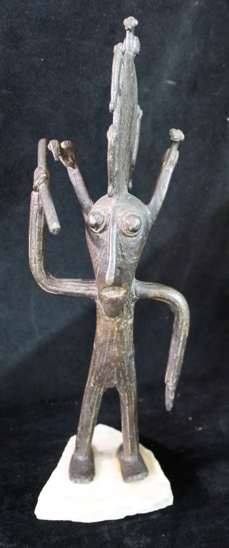 AFRICAN BRONZE FIGURE ON WHITE MARBLE BASE, 14"H: This captivating 14-inch tall African bronze figure, perched atop a white marble base, is a unique piece of African art that will surely be a conversation starter in any home. Crafted from high-qualit