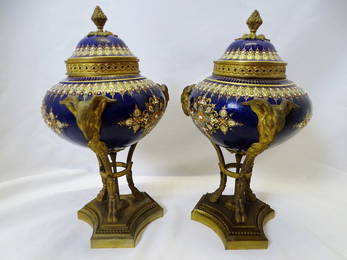 PAIR OF NINETEENTH CENTURY SEVRES BRONZE MOUNTED RAMS HEAD FIGURAL COBALT PORCELAIN COVERED URNS,