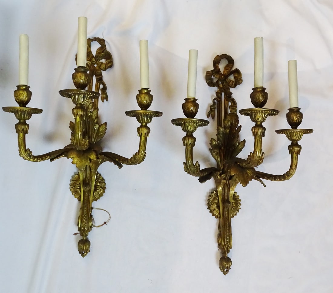 PAIR OF BRONZE THREE LIGHT SCONCES WITH RIBBON AND LEAF MOTIF, 23" X 15" X 10.5": PAIR OF BRONZE THREE LIGHT SCONCES WITH RIBBON AND LEAF MOTIF, 23" X 15" X 10.5"