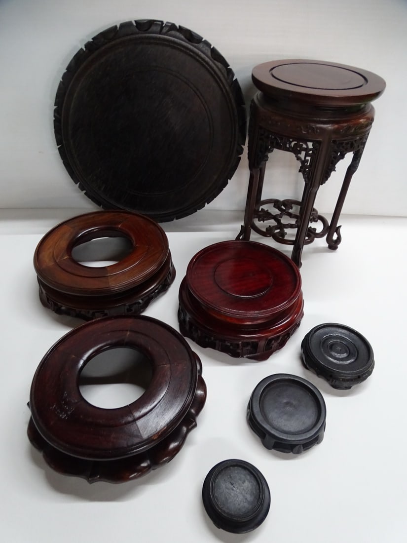 COLLECTION OF EIGHT ASIAN STANDS INCLUDING TEAK AND ROSEWOOD: This collection of eight Asian stands showcases the diversity of styles and materials used in traditional Asian furniture. The collection likely includes a variety of items, such as tea tables, plant