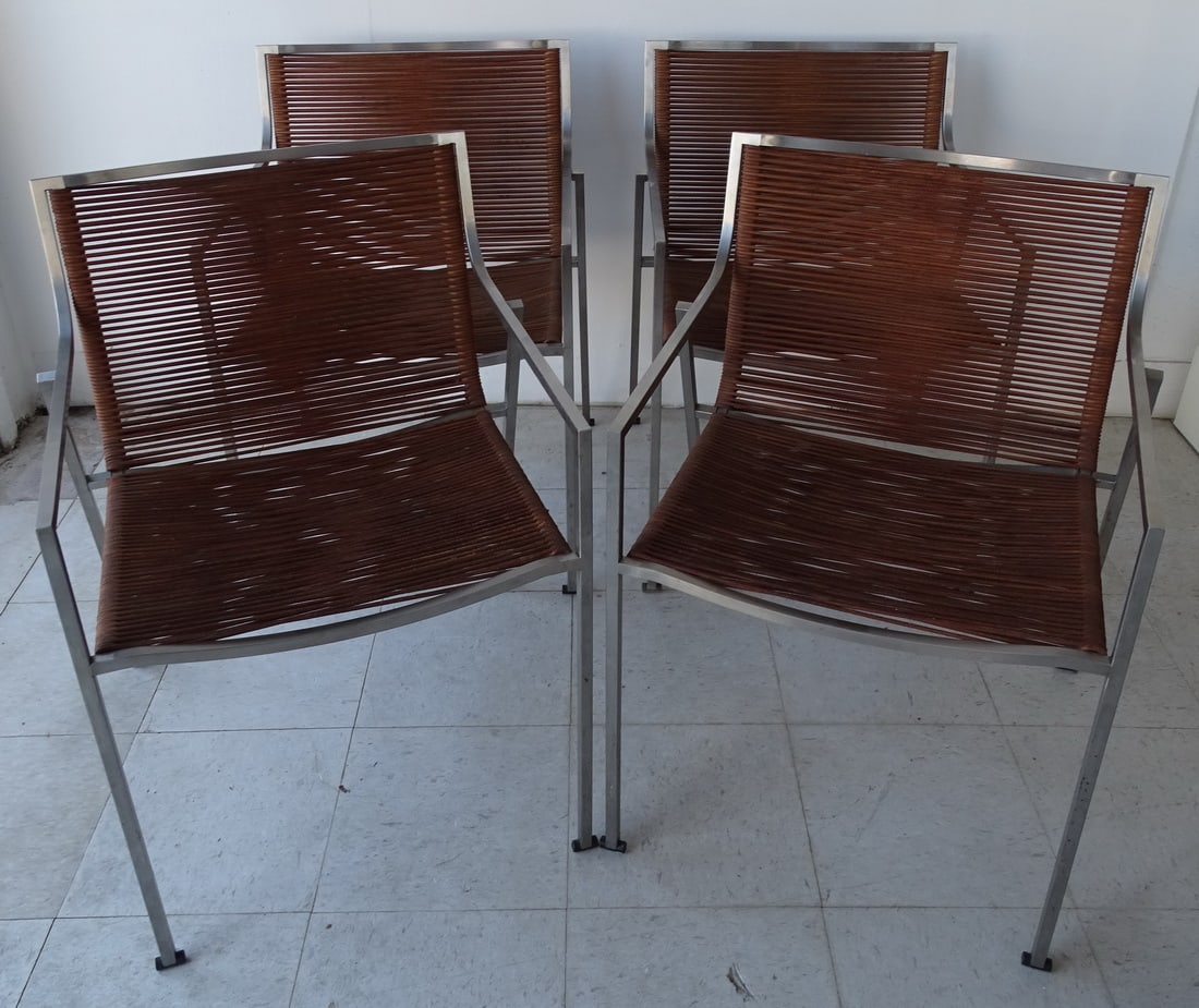 SET OF FOUR "CORO" SB01 STAINLESS STEEL AND CORD ITALIAN ARMCHAIRS: This stunning set of four "Coro" SB01 armchairs, designed by Italian master craftsman Vittorio Bonacina, embodies the elegance and sophistication of mid-century modern design. The chairs feature a sle