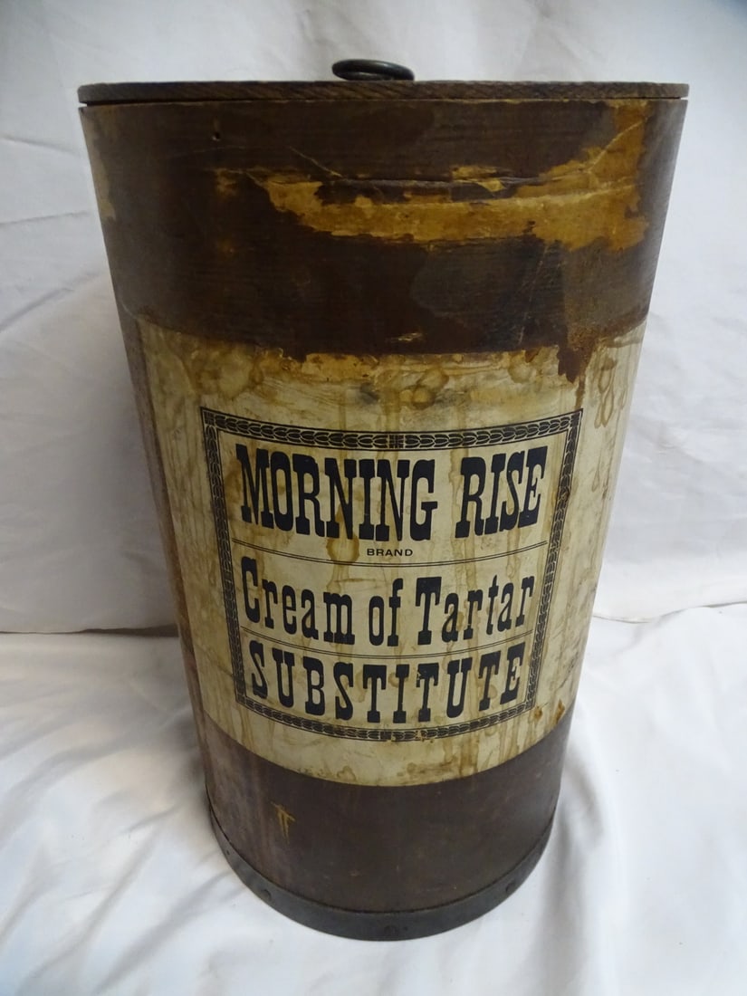 ANTIQUE CIRCULAR WOOD ADVERTISING BOX/END TABLE: This antique circular wooden advertising box or end table is a fascinating piece of historical memorabilia. The distinctive shape and the faded advertising label on the side provide clues about its or