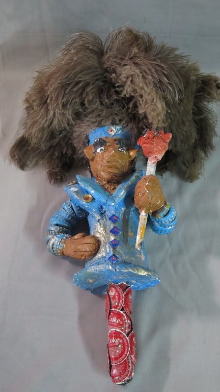 MR. IMAGINATION SCULPTURE: This unique sculpture, titled "Mr. Imagination," is a fascinating example of outsider art. Created using bottle caps and adorned with ostrich feathers for hair, the sculpture showcases the artist's cr