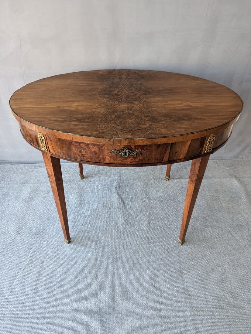 19TH CENTURY BURLED WALNUT FRENCH, BRASS MOUNTED, OVAL ONE DRAWER TABLE (1 of 16)