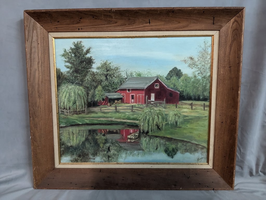 SIGNED OIL ON BOARD. "LANDSCAPE WITH BARN AND POND": This charming oil on board painting captures the serene beauty of the countryside. The artist has skillfully depicted a pastoral scene with a picturesque red barn nestled amidst lush greenery and a tr