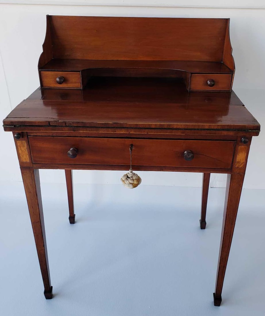 GEORGE III INLAID MAHOGANY BONHEUR DU JOUR EARLY 19TH CENTURY LADIES WRITING DESK: This elegant George III inlaid mahogany bonheur du jour, dating from the early nineteenth century, is a charming example of a ladies' writing desk. The term "bonheur du jour," meaning "daytime happine