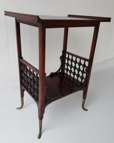 CARVED MAHOGANY TWO-TIER OCCASIONAL TABLE WITH STICK AND BALL DETAIL AND WHIMSICAL BRASS FEET