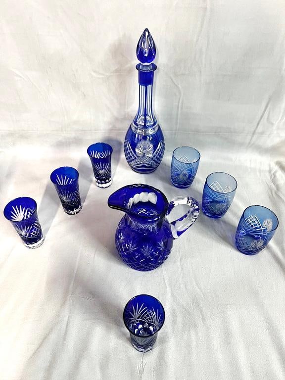 COLLECTION OF COBALT BLUE BOHEMIAN GLASS: This collection of cobalt blue Bohemian glass pieces is a testament to the artistry and craftsmanship of Czech glassmakers. The deep blue hue, combined with the intricate cut glass patterns, creates a