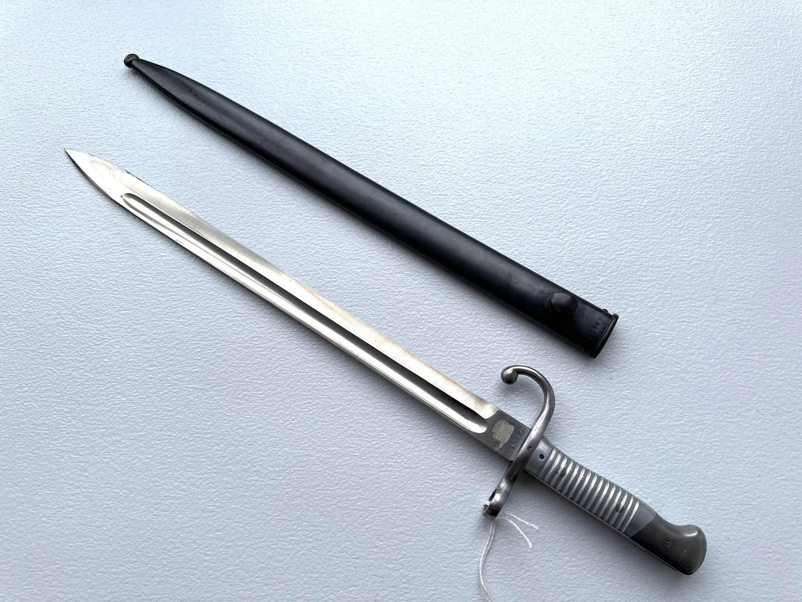 WYERSBERG & KIRSCHBAUM M1891 ARGENTINE MAUSER BAYONET: This is another image of an M1891 Argentine Mauser bayonet, also manufactured by Weyersberg & Kirschbaum (WKC). The polished blade, ribbed hilt, and distinctive hooked quillon are consistent with 