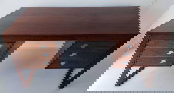 DYRLUND SMITH MID CENTURY DESK DESIGNED BY GUNNI OMANN 28.25" X 57" X 27": This striking mid-century modern desk, manufactured by Dyrlund Smith and designed by Gunni Omann, showcases the elegance and craftsmanship of Danish design. Constructed from richly grained rosewood, a