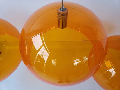 SET OF THREE MID-CENTURY KARTELL FL/Y PENDANT LAMPS BY FERRUCCIO LAVIANI: This set of three Kartell FL/Y pendant lamps is a striking example of Italian mid-century modern design. Created by renowned designer Ferruccio Laviani, these iconic lights feature large, spherical sh