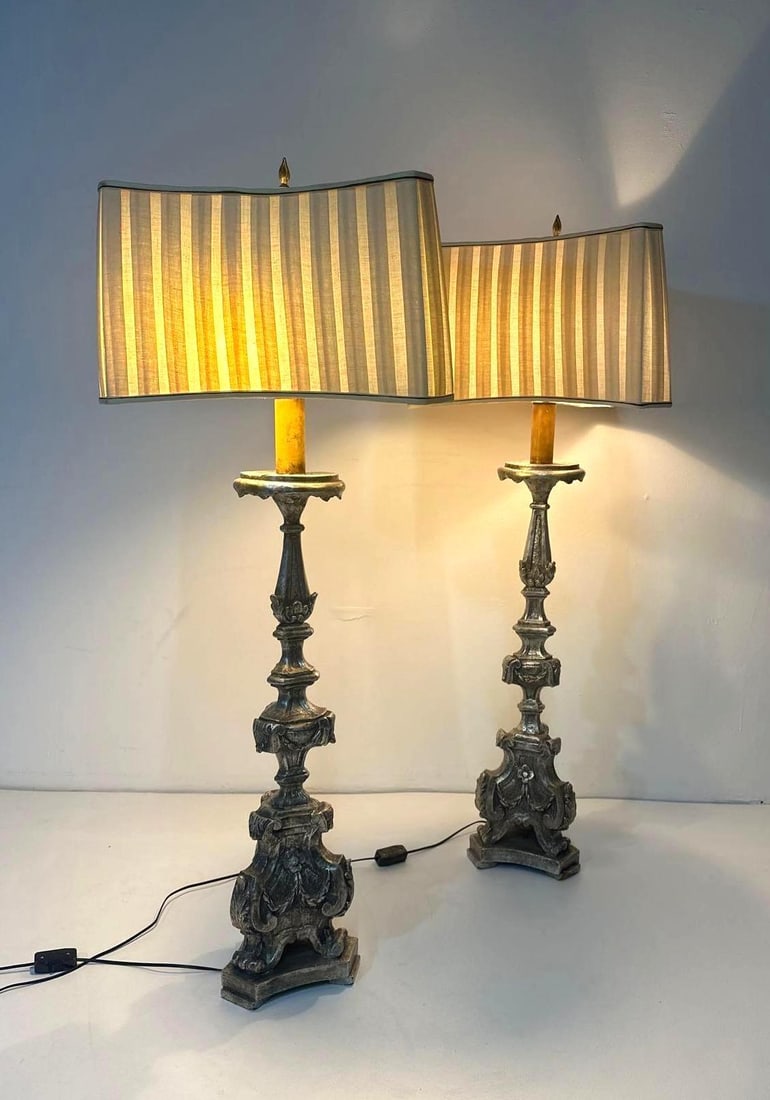 PAIR OF PIETRO CIPRIANI STYLE HOLLYWOOD REGENCY BAROQUE LAMPS: This exquisite pair of lamps evokes the grandeur of the Baroque era with their dramatic flourishes and opulent detailing. Inspired by the work of the renowned Italian sculptor Pietro Cipriani, the lam