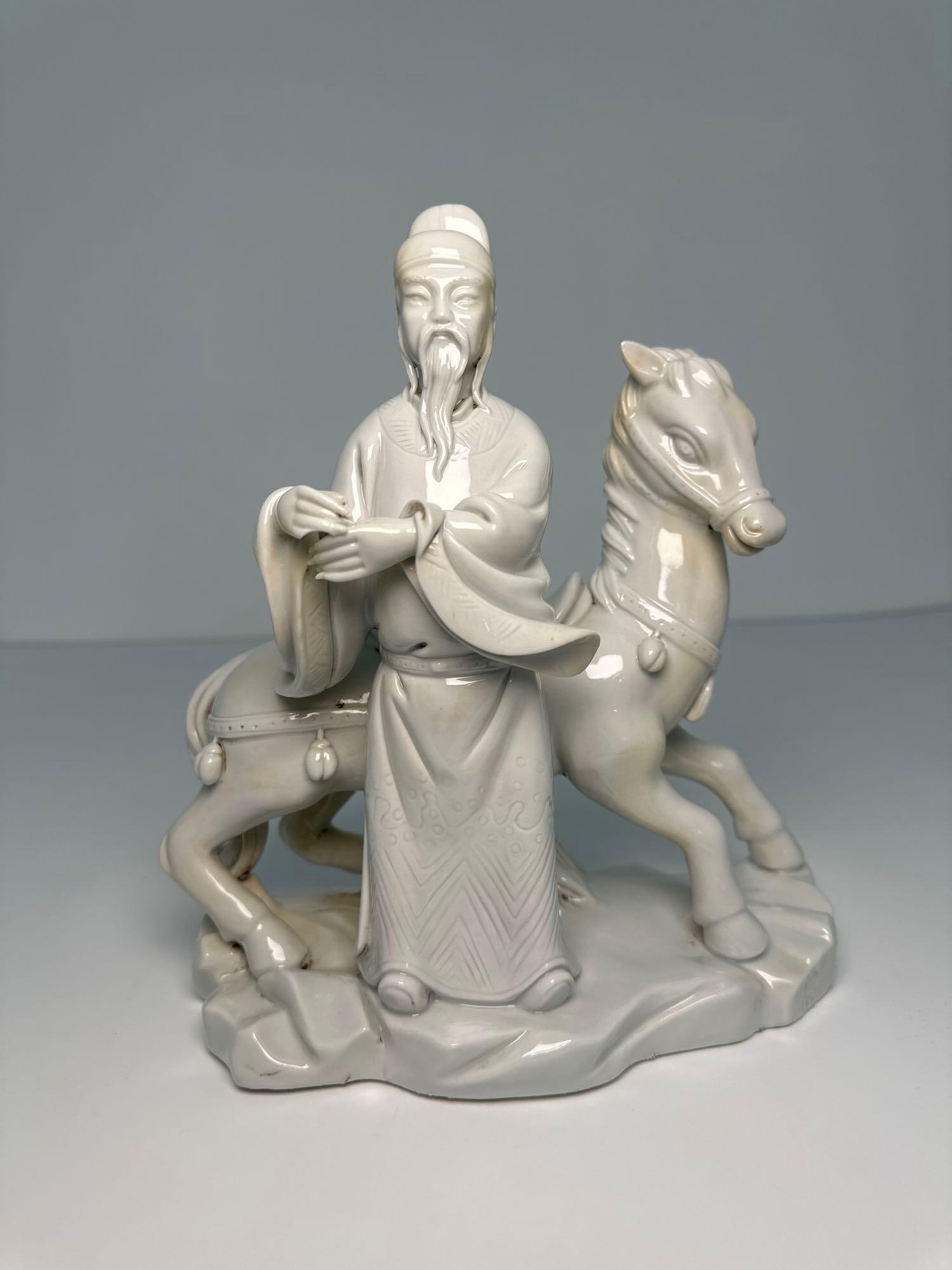 VALUE LOT: Chinese Blanc De Chine Dehua Porcelain Scholar Statue With Horse [some losses]: This Chinese Blanc de Chine Dehua porcelain statue, measuring 9 inches tall and 8 inches wide, depicts a figure, possibly a scholar or official, seated on a horse, showcasing the artistry of Dehua por