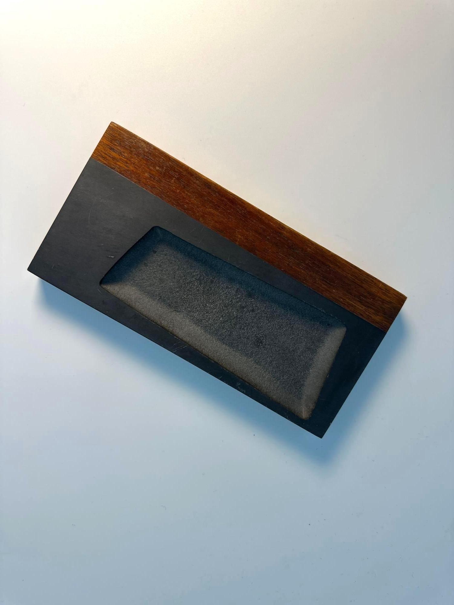 HAPSWELL HOUSE SLATE AND HARDWOOD CATCHALL TRAY: This sleek catchall tray by Hapswell House is a sophisticated modern valet tray, combining the natural beauty of slate and rish hardwood (likely mahogany). The tray features a smooth, dark slate surfa