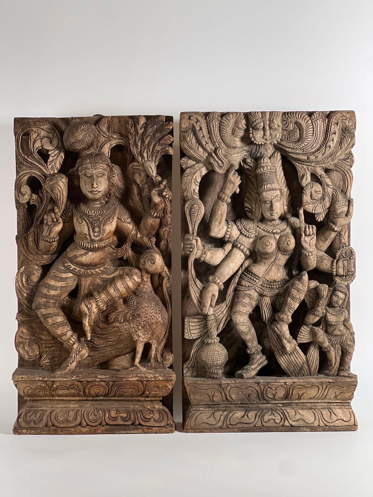 PAIR OF INDONESIAN CARVED WOODEN RELIEF SCULPTURES | HINDU DEITY PANELS: This exquisite pair of Indonesian or Indian carved wooden relief sculptures showcases the intricate artistry of traditional Southeast Asian craftsmanship, featuring detailed depictions of Hindu deitie
