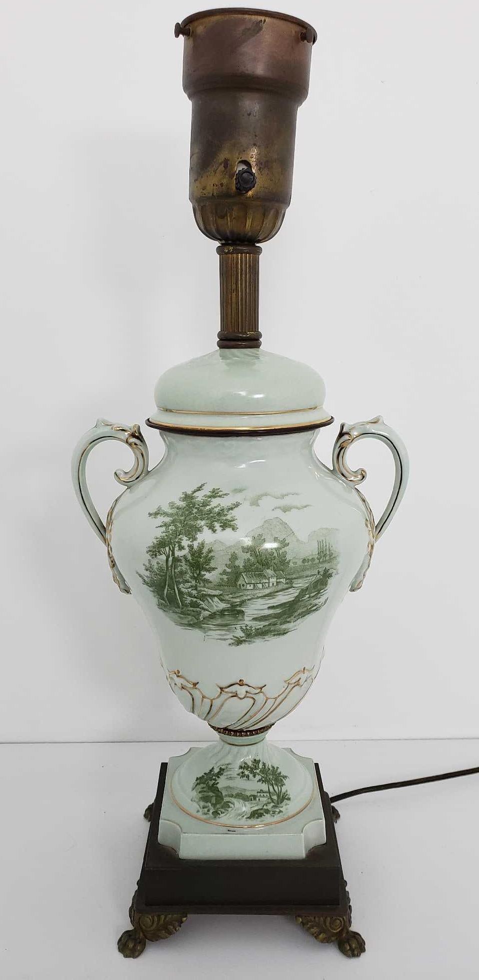 VALUE LOT: VINTAGE PORCELAIN LAMP WITH SCENIC DECORATION AND GILT ACCENTS: This elegant porcelain lamp, standing 22.5 inches high, brings a touch of pastoral tranquility and classic elegance to any interior space. The lamp's porcelain body, shaped in a traditional urn or