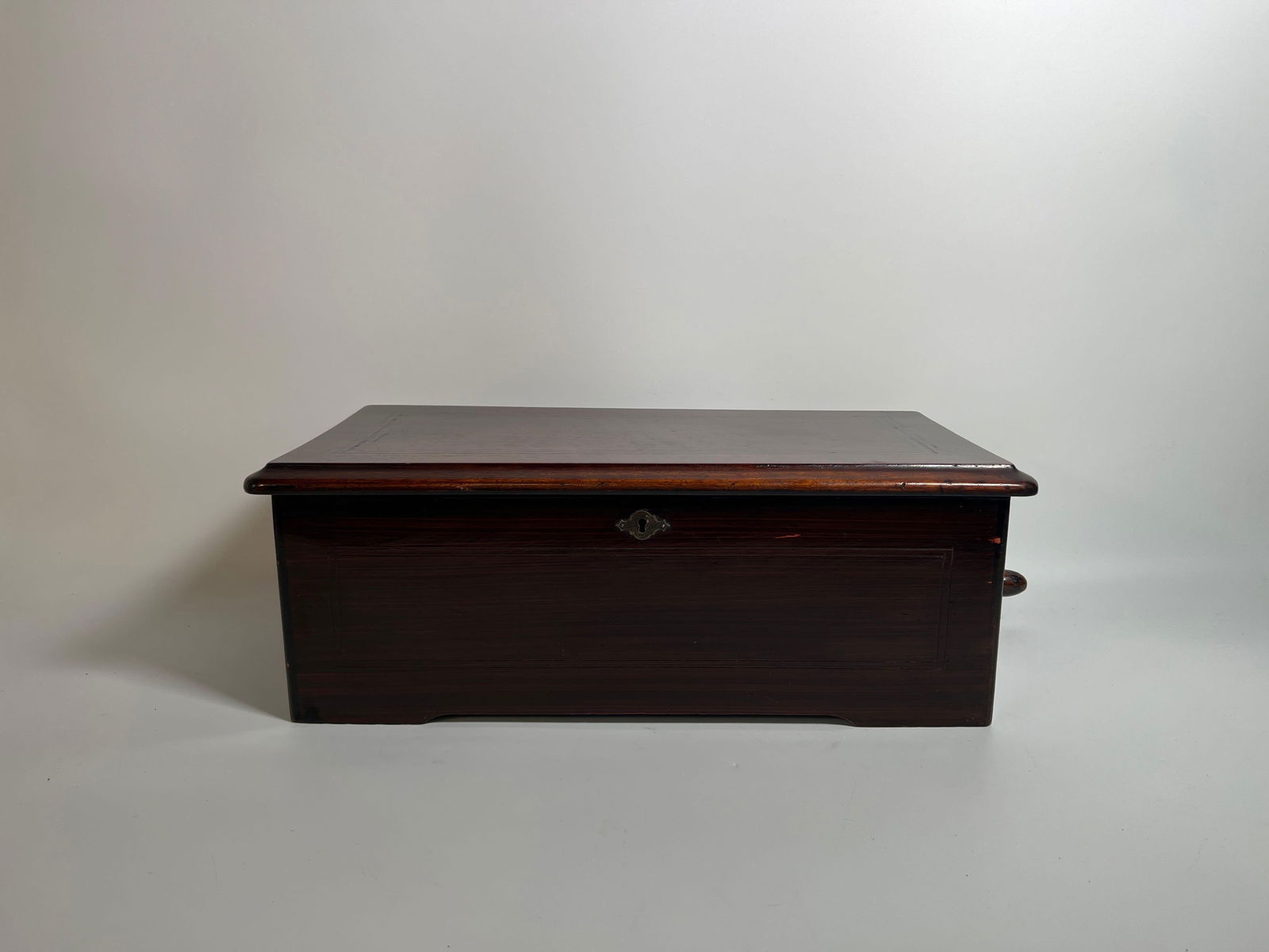 ANTIQUE LATE 19TH CENTURY MERMOD FRERES SWISS CYLINDER MUSIC BOX: An antique late 19th-century Mermod Freres Swiss cylinder music box, housed in a dark wooden case with an ornate tune sheet inside the lid, showcasing the intricate mechanical components. Dimensions: