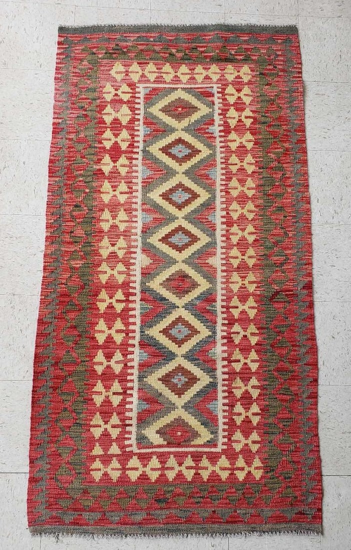 VINTAGE KILIM RUG: Area Rug Dimensions: 39" W X 77" L Artist or Maker: Unknown Notes: Although care is taken to photograph and describe the item, absence of a condition report does not imply perfect condition. I