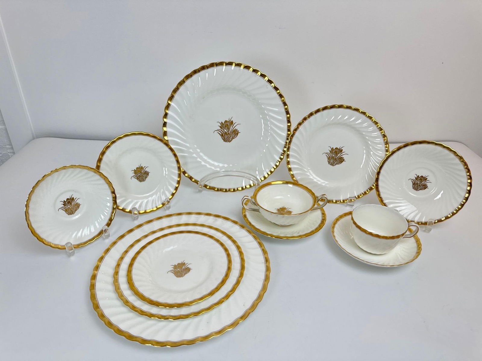 MINTON SCALLOPED BONE CHINA SET W/ GOLD DETAILS: A bone China set by Minton with 92 pieces pattern H-4765 12 dinner plates 10.75in diameter 12 appetizer plates 8in diameter. 12 bread plates 6.25in diameter 11 dessert plates 6.25in diameter 12 desse